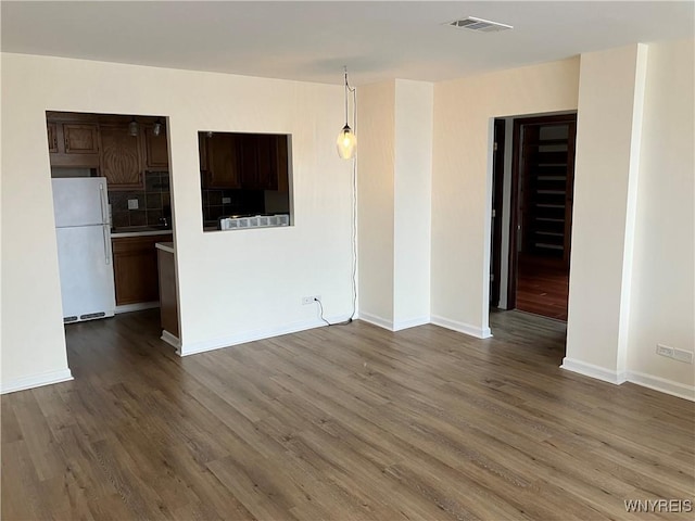 5854 Main St Unit 407, Amherst, NY 14221 - empty room featuring dark wood-type flooring and baseboards