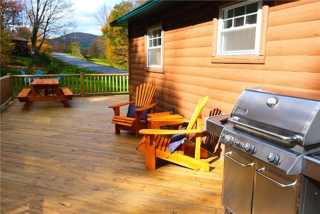 deck with grilling area and a mountain view