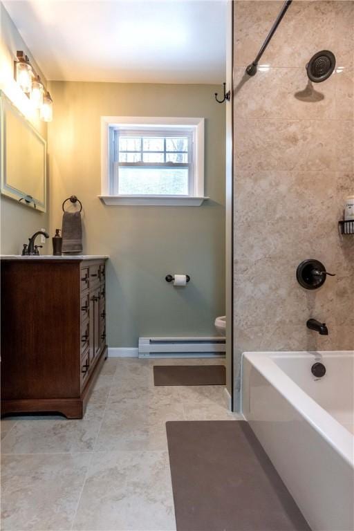bathroom featuring baseboard heating, bathtub / shower combination, vanity, and baseboards