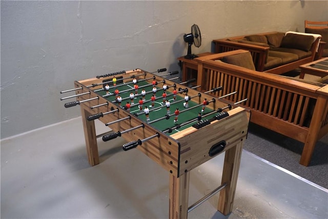 recreation room featuring concrete floors