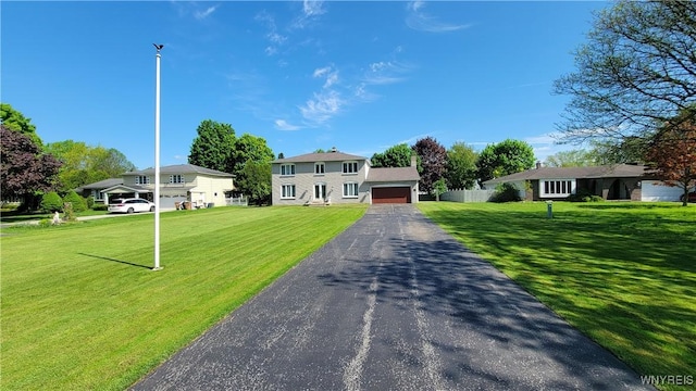 view of front of home with a garage, a front yard, and a residential view