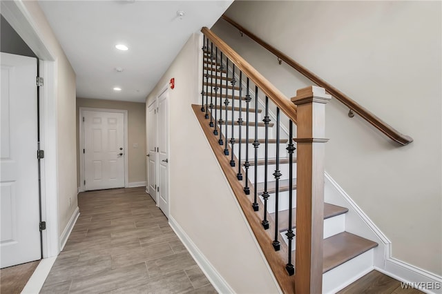 staircase with recessed lighting and baseboards