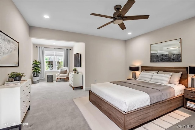 bedroom with light colored carpet, recessed lighting, and a ceiling fan