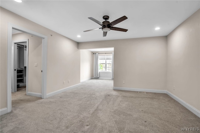carpeted spare room featuring a ceiling fan, recessed lighting, and baseboards
