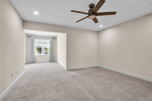empty room with a ceiling fan, light carpet, baseboards, and recessed lighting