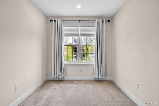 empty room featuring baseboards, carpet flooring, and recessed lighting