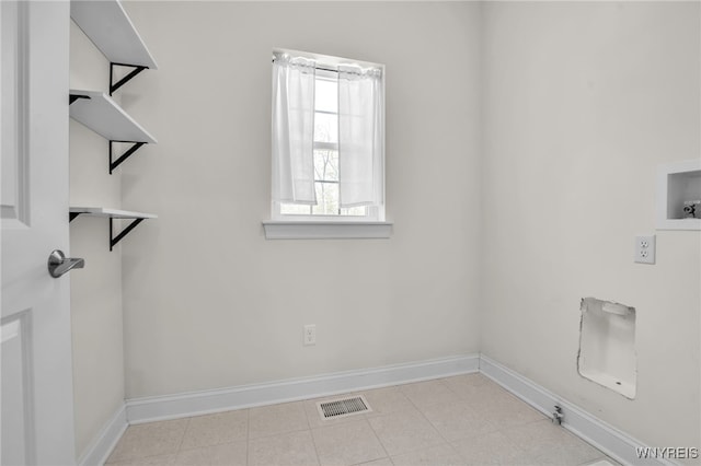 clothes washing area with hookup for a washing machine and baseboards