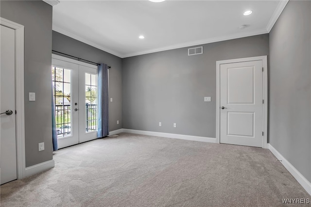 spare room featuring carpet flooring, french doors, crown molding, baseboards, and recessed lighting
