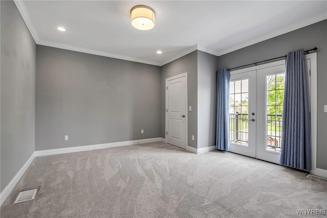carpeted empty room featuring crown molding, french doors, baseboards, and recessed lighting