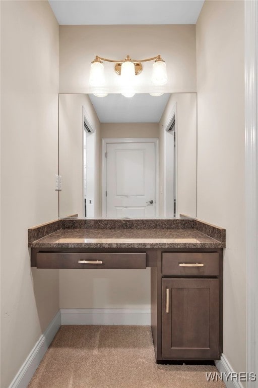 bathroom featuring vanity and baseboards