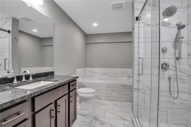 full bathroom with a stall shower, marble finish floors, a bath, vanity, and toilet