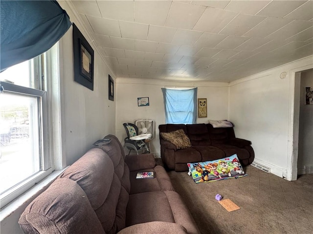 living area with plenty of natural light, carpet, and crown molding