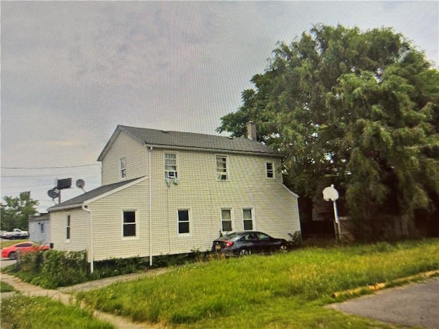 view of side of property with a chimney