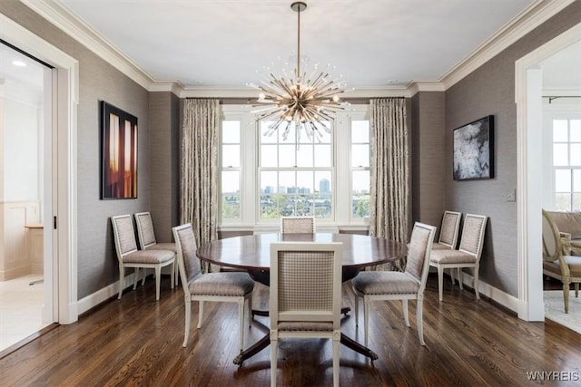dining area featuring dark wood-style flooring, baseboards, ornamental molding, a chandelier, and a textured wall