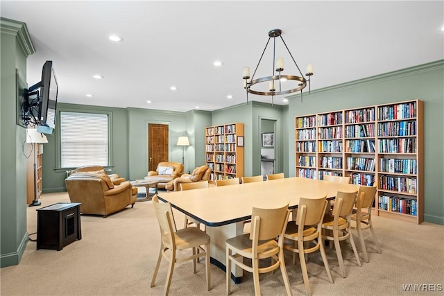 dining area featuring light colored carpet, crown molding, recessed lighting, and a chandelier