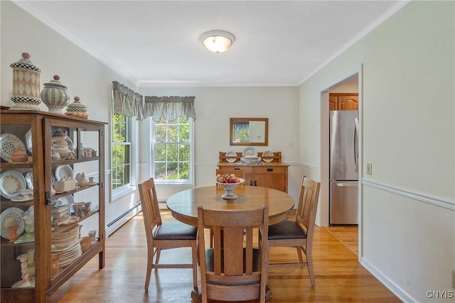 4268 Colorado Run, Onondaga, NY 13215 - dining space with light wood finished floors, a baseboard heating unit, and ornamental molding