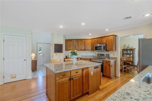 4268 Colorado Run, Onondaga, NY 13215 - kitchen with stainless steel appliances, light wood-style flooring, light stone counters, and recessed lighting