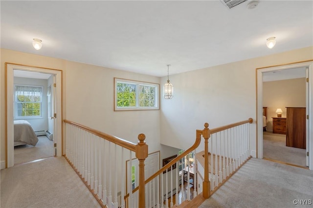 4268 Colorado Run, Onondaga, NY 13215 - hallway with an upstairs landing, plenty of natural light, carpet floors, and baseboard heating