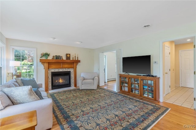 4268 Colorado Run, Onondaga, NY 13215 - living area with a high end fireplace, light wood-style floors, and a baseboard radiator