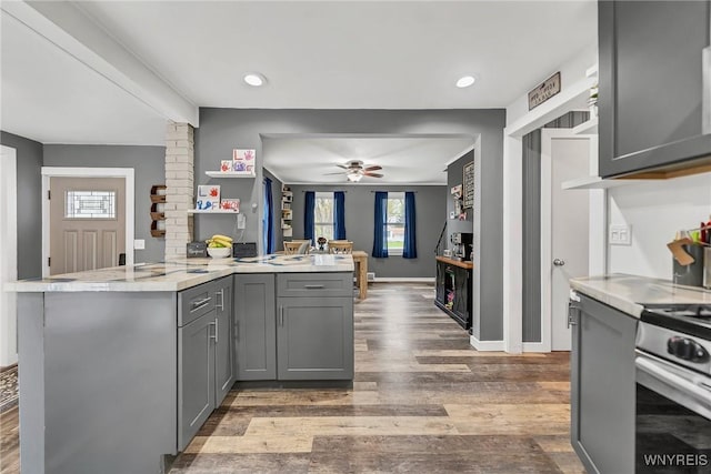 11965 Clinton St, Marilla, NY 14004 - kitchen with a peninsula, gray cabinetry, ceiling fan, wood finished floors, and light countertops