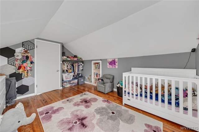 11965 Clinton St, Marilla, NY 14004 - bedroom with wood finished floors, vaulted ceiling, and a nursery area