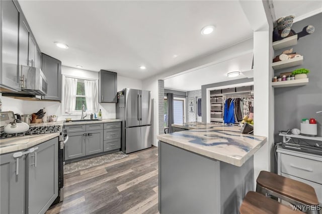 11965 Clinton St, Marilla, NY 14004 - kitchen featuring stainless steel appliances, gray cabinetry, light countertops, wood finished floors, and a sink