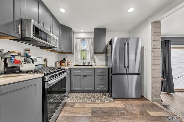 11965 Clinton St, Marilla, NY 14004 - kitchen featuring appliances with stainless steel finishes, a sink, gray cabinetry, light wood finished floors, and recessed lighting