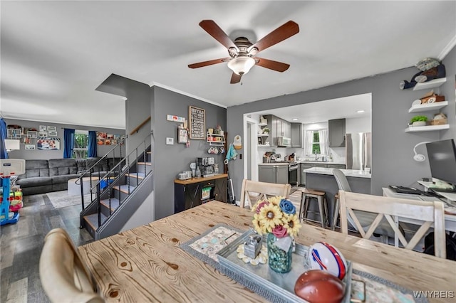 11965 Clinton St, Marilla, NY 14004 - dining room featuring a ceiling fan, stairway, and wood finished floors