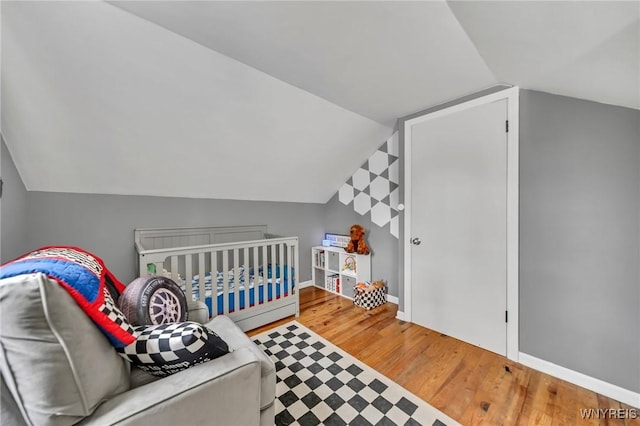 11965 Clinton St, Marilla, NY 14004 - bedroom with lofted ceiling, wood finished floors, and baseboards