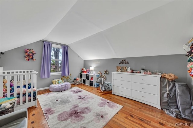 11965 Clinton St, Marilla, NY 14004 - bedroom with wood finished floors, vaulted ceiling, and a nursery area