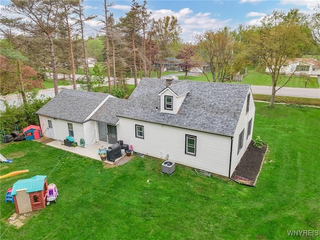 11965 Clinton St, Marilla, NY 14004 - back of house with roof with shingles, a lawn, a patio, and central AC