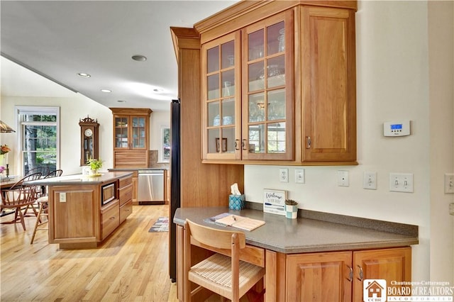32 Howard Hanson Ave, Chautauqua, NY 14722 - kitchen featuring stainless steel appliances, light wood-style flooring, brown cabinets, a center island, and recessed lighting