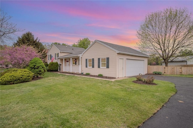 tri-level home featuring asphalt driveway and a garage