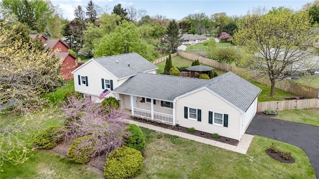 aerial view of property and surrounding area featuring a tree filled landscape