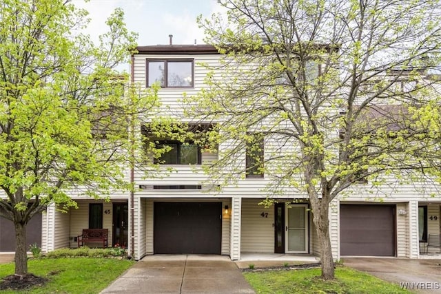 view of front facade with covered porch, driveway, and an attached garage