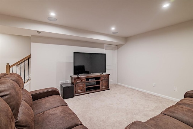 living room with recessed lighting, light colored carpet, and baseboards