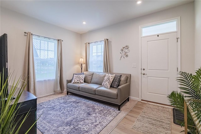 living room with light wood-style floors and recessed lighting