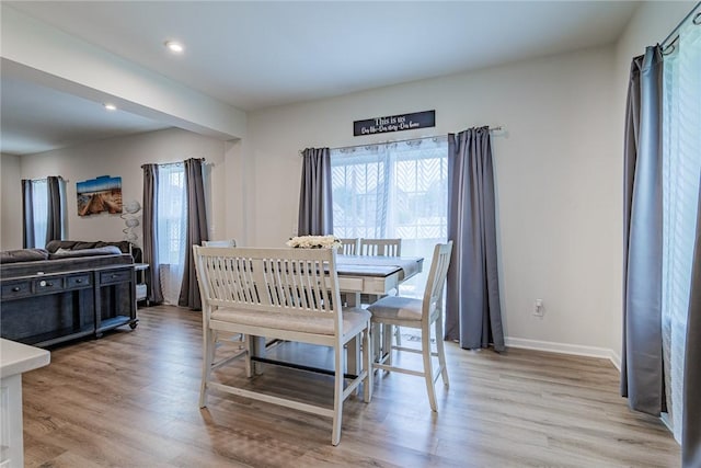 dining room with light wood-style flooring, baseboards, and recessed lighting