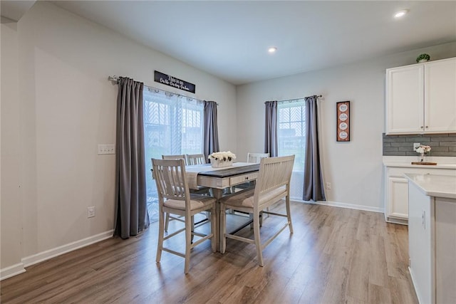 dining area with light wood finished floors, recessed lighting, and baseboards