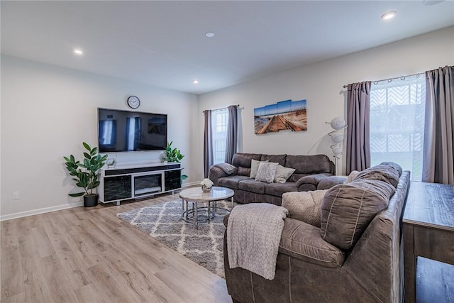 living room with wood finished floors, recessed lighting, and baseboards