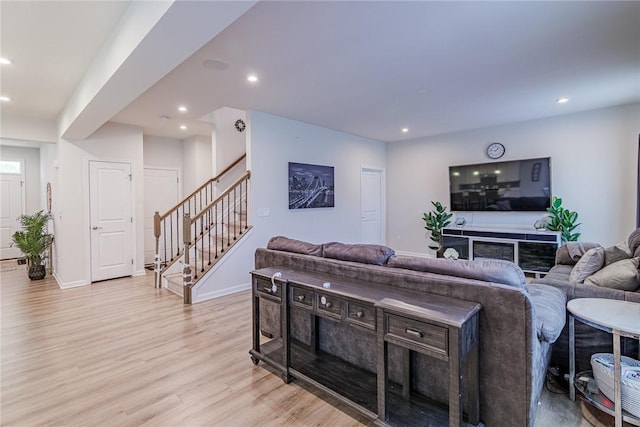 living area featuring light wood-style flooring, stairway, recessed lighting, and baseboards
