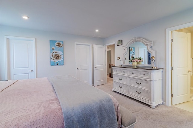 bedroom with light carpet, recessed lighting, and baseboards