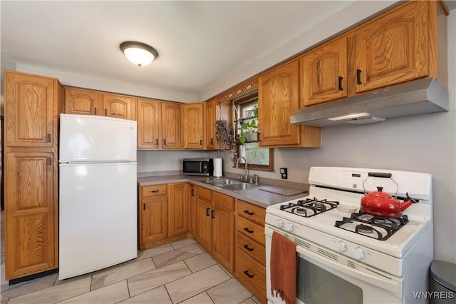30 Schultz Rd, Orchard Park, NY 14127 - kitchen featuring white appliances, under cabinet range hood, a sink, brown cabinetry, and light countertops