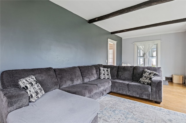 living room featuring wood finished floors and beamed ceiling