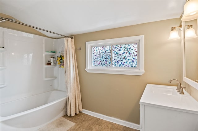 bathroom featuring shower / bath combo with shower curtain, vanity, wood finished floors, and baseboards