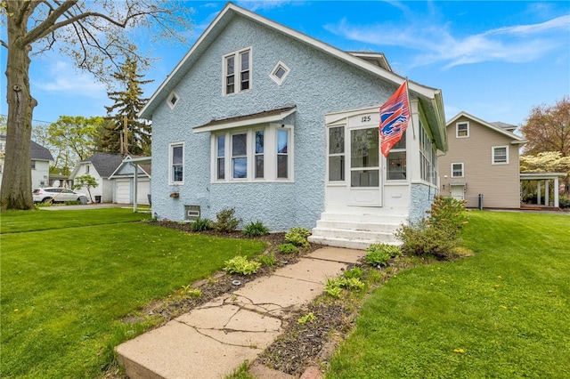 back of property featuring a yard, entry steps, and a garage