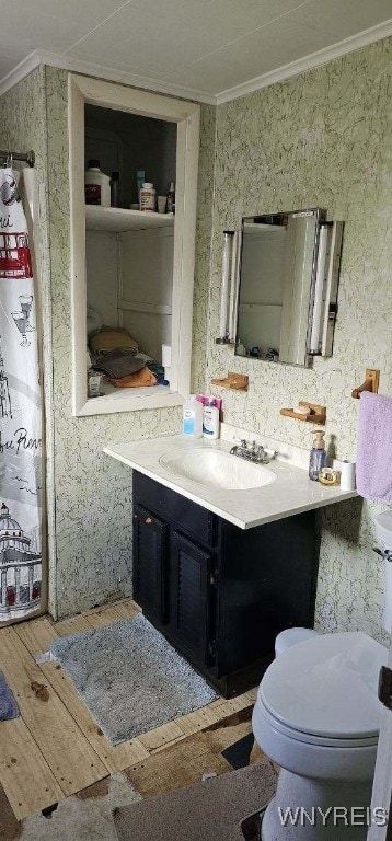 12866 Genesee Rd, Sardinia, NY 14030 - bathroom with ornamental molding, vanity, toilet, and wood finished floors