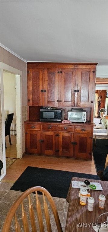 12866 Genesee Rd, Sardinia, NY 14030 - kitchen with crown molding, brown cabinets, light wood-style flooring, and dark countertops