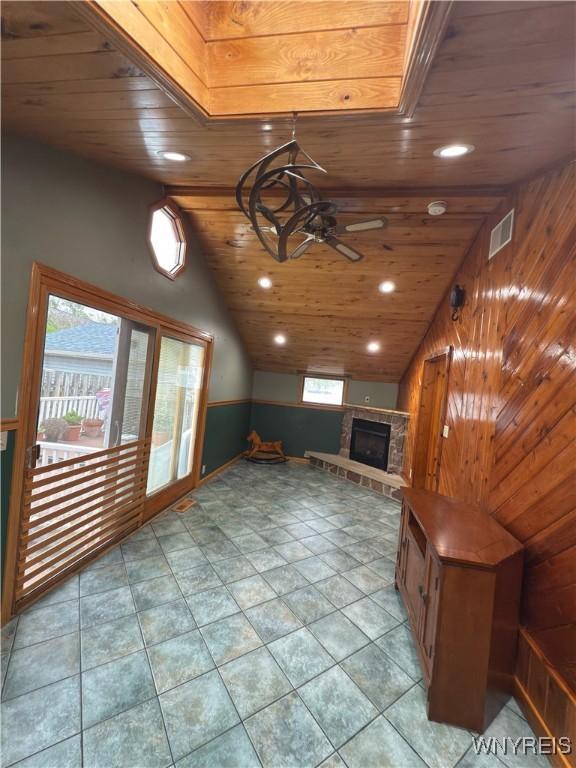 116 Fuller Ave, Tonawanda-City, NY 14150 - additional living space featuring wood ceiling, a ceiling fan, wood walls, lofted ceiling, and a glass covered fireplace