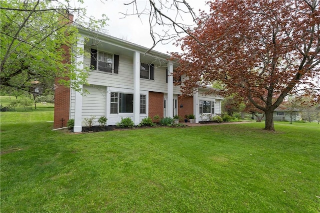 52 High St, Alfred, NY 14802 - greek revival inspired property with a front yard, a chimney, and brick siding